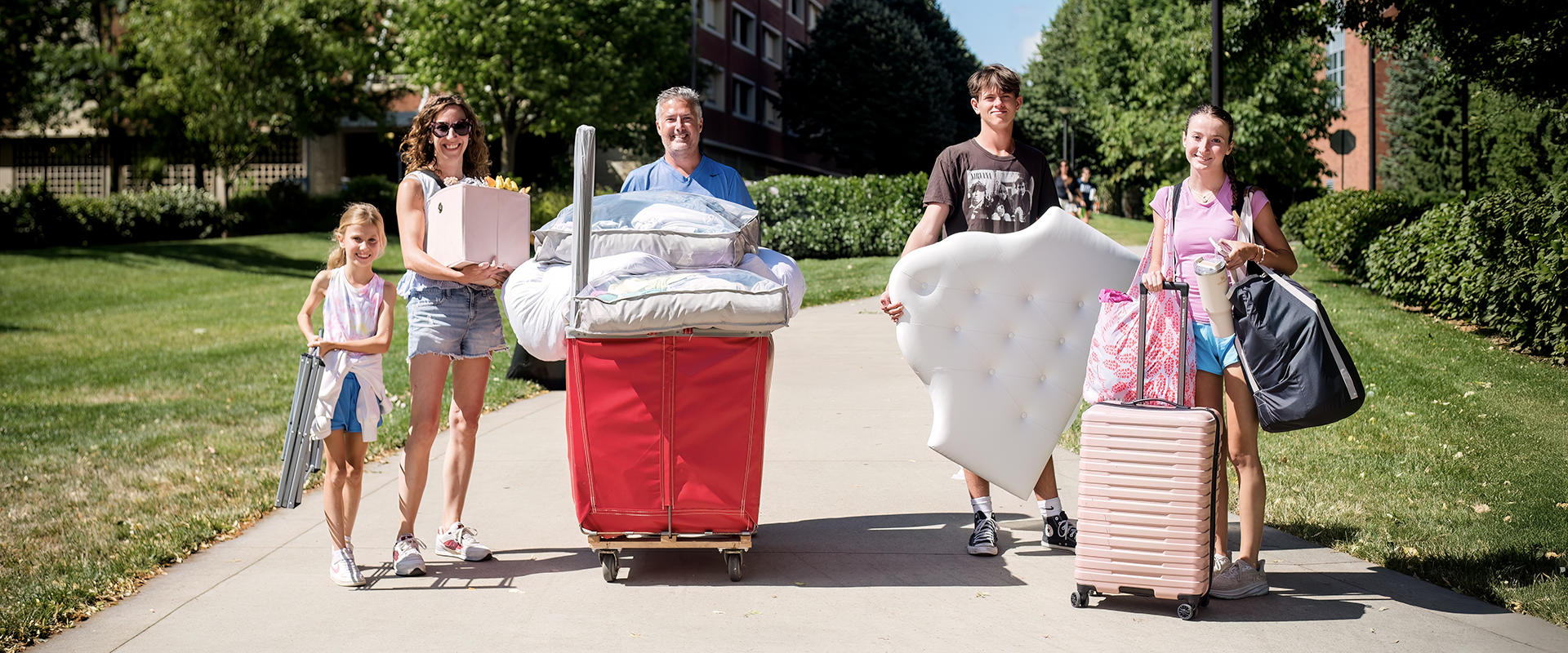 Arrival A family helps student with moving in during Arrival
